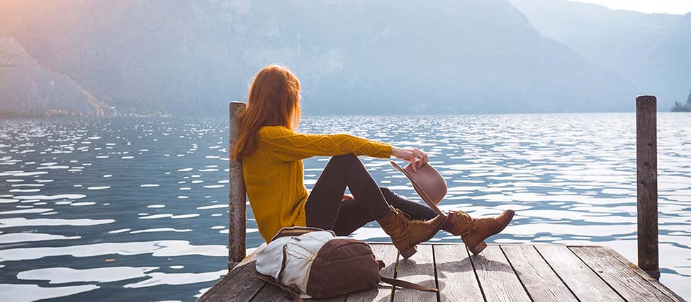A woman on a dock overlooking a lake